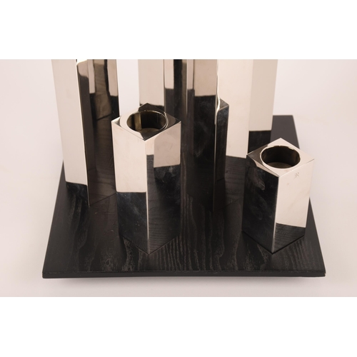 1253 - A set of six graduated chrome sculptural tealight holders on a wooden base, signed ER, 83cm. General... 