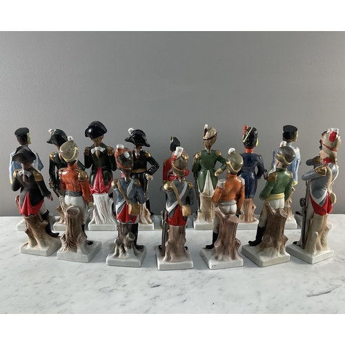 1294 - A collection of sixteen continental porcelain figures of soldiers the majority bearing inscriptions ... 