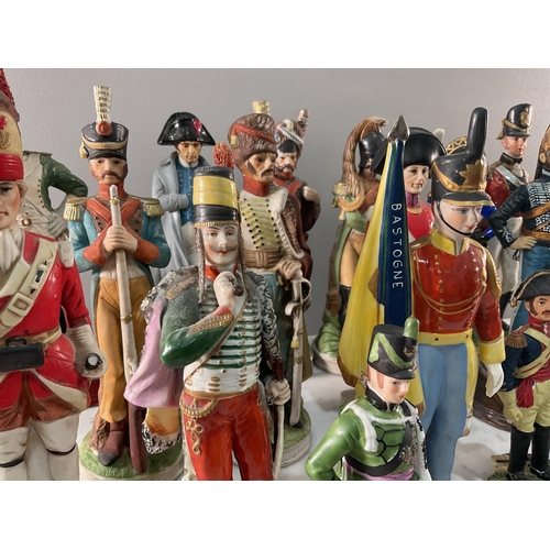 1295 - A large collection of both porcelain and resin continental figures of soldiers, of varying size and ... 