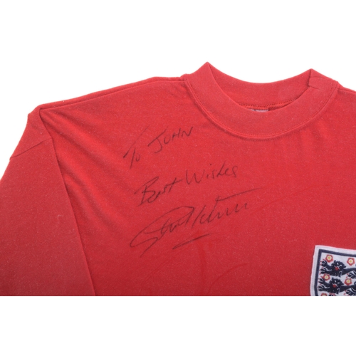 1310 - A collection of football memorabilia, comprising a Sir Geoff Hurst signed replica England football s... 