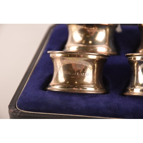 1333 - A selection of silver items including, a box of four napkin rings dated 1925, a further napkin ring ... 