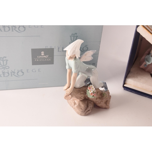 102 - A collection of two boxed Lladro figures, one of girl with flowers, signed to base with original pap... 