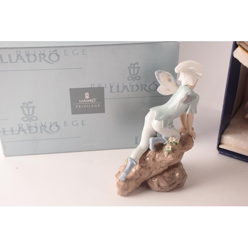 102 - A collection of two boxed Lladro figures, one of girl with flowers, signed to base with original pap... 