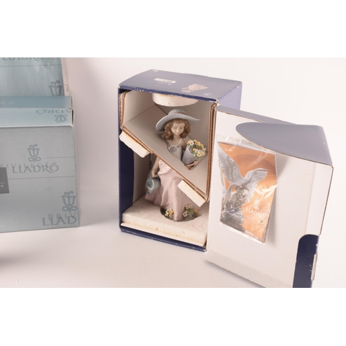 102 - A collection of two boxed Lladro figures, one of girl with flowers, signed to base with original pap... 