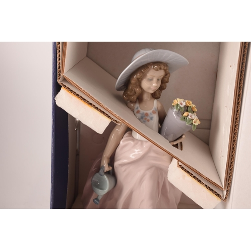 102 - A collection of two boxed Lladro figures, one of girl with flowers, signed to base with original pap... 