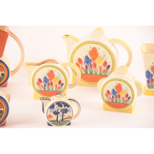 103 - After Clarice Cliff; a collection of ceramics stamped Chelsea Works Burslem comprising two teapots, ... 