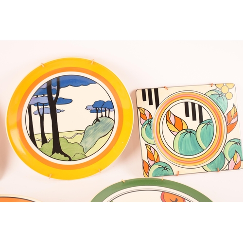 121 - After Clarice Cliff; a collection of decorative plates comprising two rectangular plates from the Ar... 