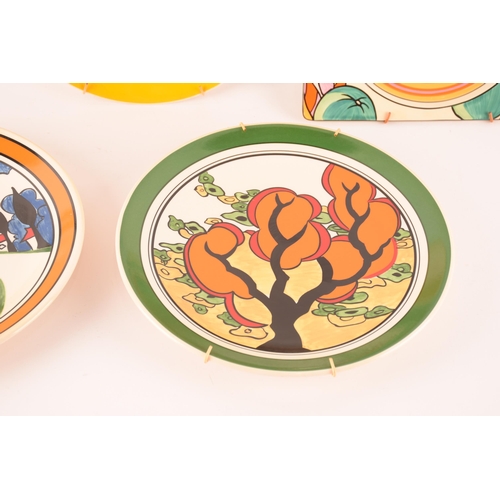 121 - After Clarice Cliff; a collection of decorative plates comprising two rectangular plates from the Ar... 