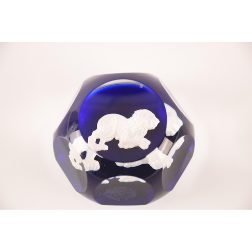 132 - Baccarat; a collection of four sulphide paperweights having centeral motifs on blue ground, external... 