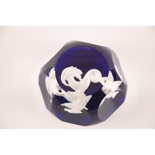 132 - Baccarat; a collection of four sulphide paperweights having centeral motifs on blue ground, external... 