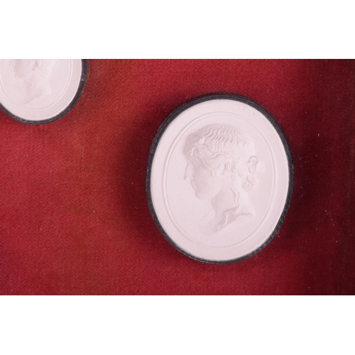 137 - A mid-19th century style set of fourteen Grand Tour plaster intaglios, in the Classical taste, in a ... 