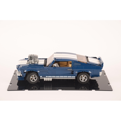 143 - A pre constructed Lego Ford Mustang in custom built display cabinet, having various working mechanic... 