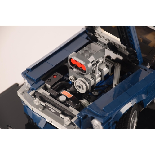 143 - A pre constructed Lego Ford Mustang in custom built display cabinet, having various working mechanic... 