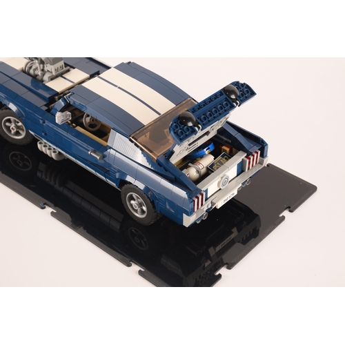 143 - A pre constructed Lego Ford Mustang in custom built display cabinet, having various working mechanic... 