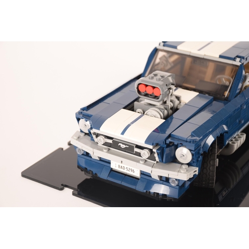 143 - A pre constructed Lego Ford Mustang in custom built display cabinet, having various working mechanic... 