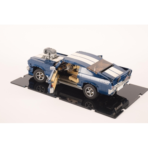 143 - A pre constructed Lego Ford Mustang in custom built display cabinet, having various working mechanic... 