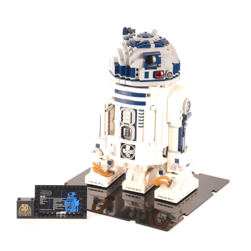 148 - A pre-constructed Lego Star Wars R2D2 in custom-built display cabinet, having various working mechan... 