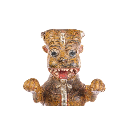 27 - An Indian painted and carved wood figure of a crowned tiger, standing on his hind legs with arms out... 