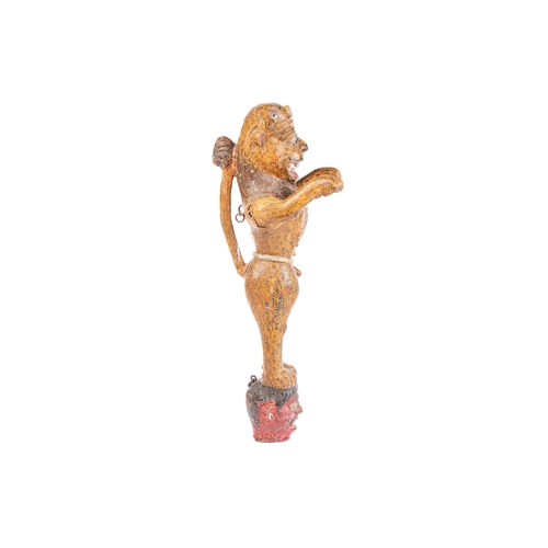 27 - An Indian painted and carved wood figure of a crowned tiger, standing on his hind legs with arms out... 