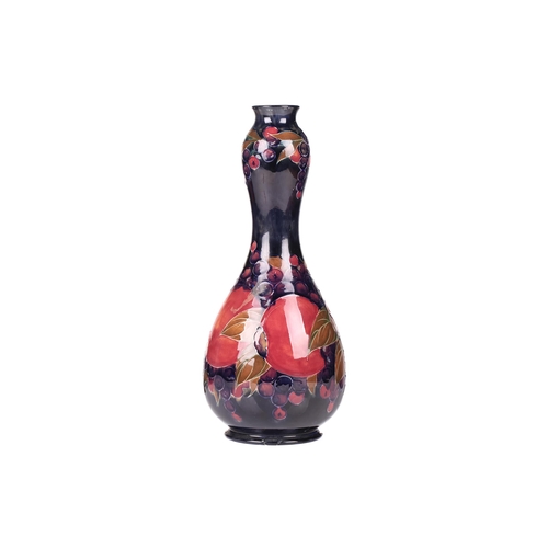 67 - William Moorcroft, a large Pomegranate pattern vase, circa 1915, of double gourd form with impressed... 