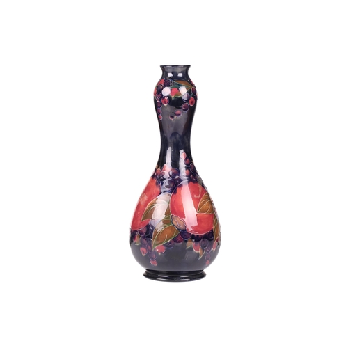 67 - William Moorcroft, a large Pomegranate pattern vase, circa 1915, of double gourd form with impressed... 