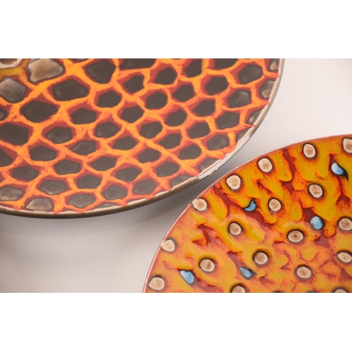 79 - Anita Harris; a collection of ceramics comprising three large plates of varying pattern, signed to b... 