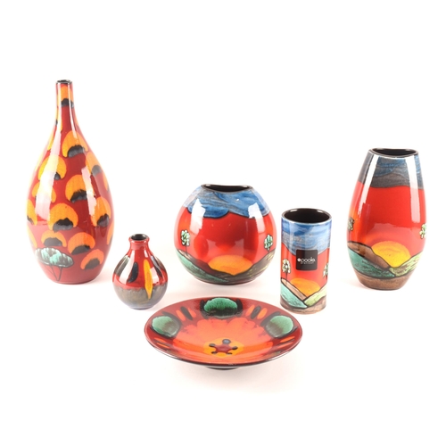 85 - Poole; a collection of ceramics comprising a Manhatten shape vase, a Purse shape vase and a Pillar v... 