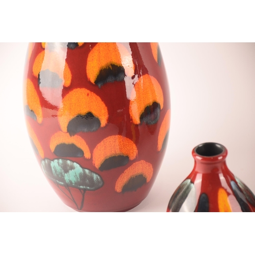 85 - Poole; a collection of ceramics comprising a Manhatten shape vase, a Purse shape vase and a Pillar v... 