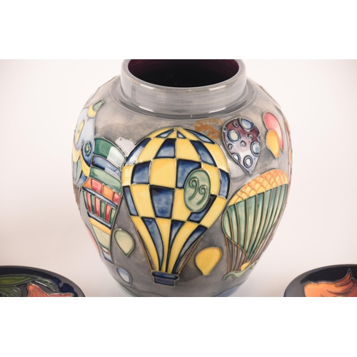 89 - A large Moorcroft vase featuring decoration of hot air balloons, together with a smaller ginger jar ... 