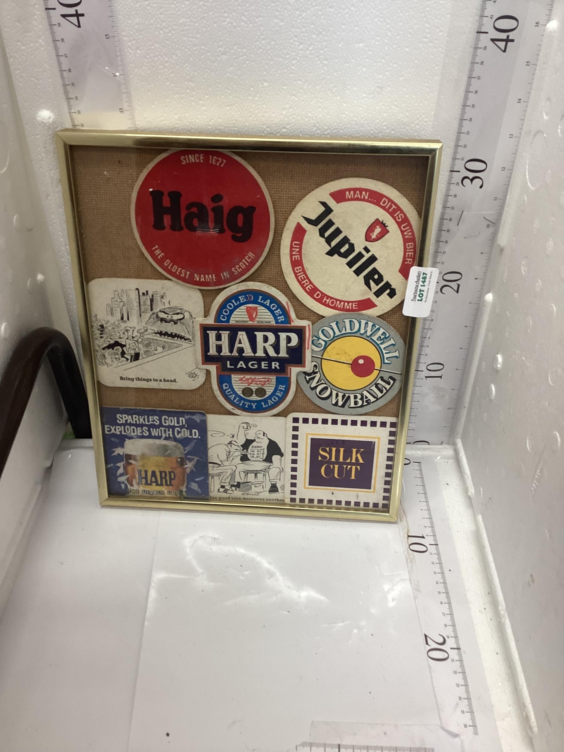 framed old beer mats