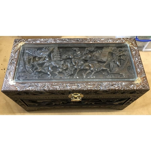 1051 - Chinese carved wood chest with panels depicting war battles and brass mounts and lock. 89cm w x 42cm... 