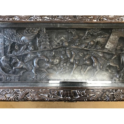 1051 - Chinese carved wood chest with panels depicting war battles and brass mounts and lock. 89cm w x 42cm... 