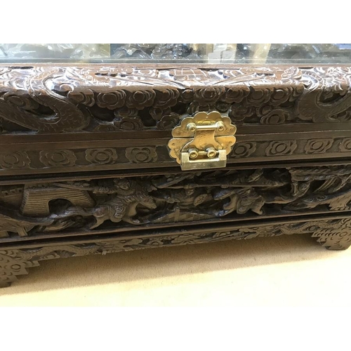 1051 - Chinese carved wood chest with panels depicting war battles and brass mounts and lock. 89cm w x 42cm... 