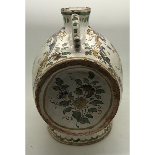 106 - A faience barrel shape spirit flask with polychrome decoration. Marked to the base with script F. 15... 