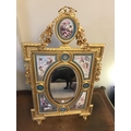 Porcelain and gilt metal decorative Sevres style table mirror. Oval bevel edged mirror surrounded by... 