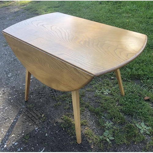 1364 - Ercol oval topped drop leaf table on tapered legs. 125 w open x 114cms, 72cms h.