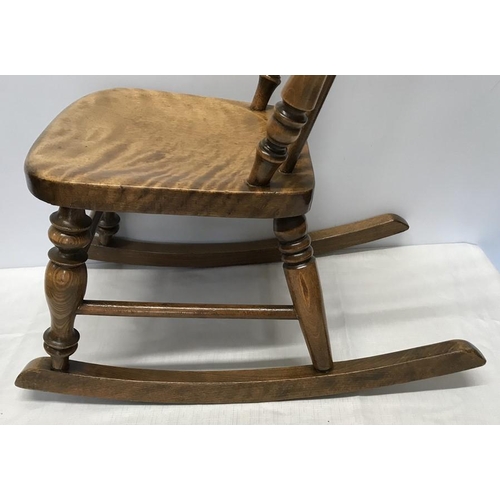 1375 - A child's stick back rocking chair height to seat 29cm, height to back 59cm and width of seat 28cm.