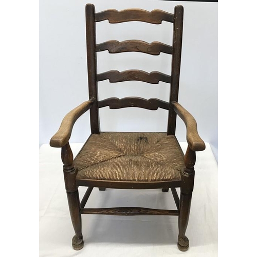 1407 - A child's rush seated oak armchair, height to seat 32cms, height to back 76cms, 42cms w.