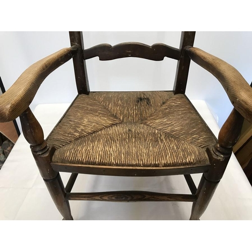 1407 - A child's rush seated oak armchair, height to seat 32cms, height to back 76cms, 42cms w.