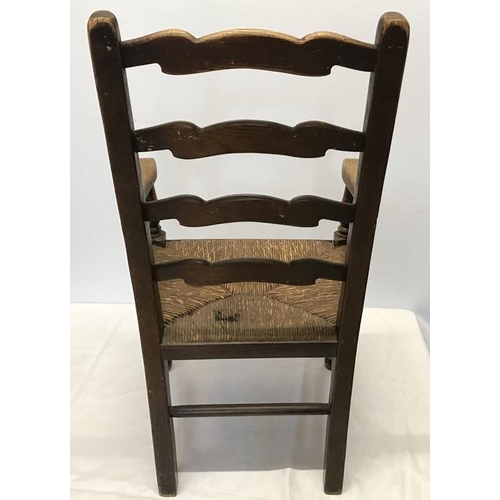 1407 - A child's rush seated oak armchair, height to seat 32cms, height to back 76cms, 42cms w.