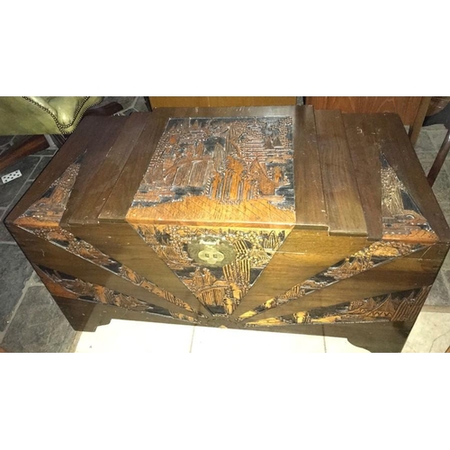 1420 - A camphorwood chest with oriental carving to top and sides.