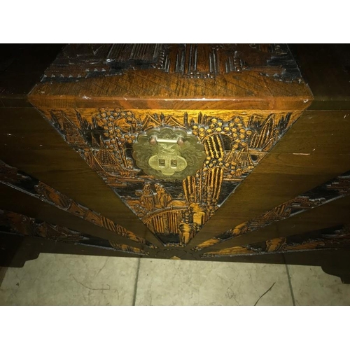 1420 - A camphorwood chest with oriental carving to top and sides.