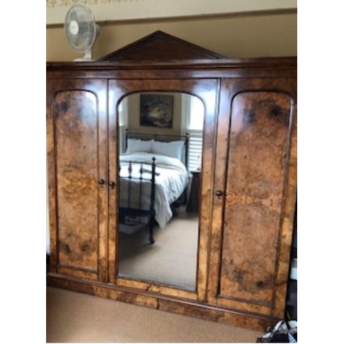 1423 - A good quality 19thC burr walnut triple wardrobe, central mirrored door and fitted interior. 212 w x... 