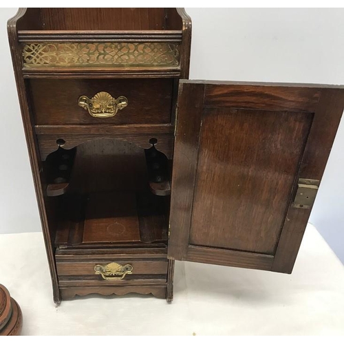 1429 - Oak smokers cabinet, carved door panel, brass gallery and fittings. Stoneware tobacco jar with chipp... 