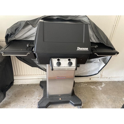 1440 - A large gas Ducane barbeque with protective cover.