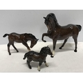 Royal Doulton brown horse and foal, horse 19.5cms h, foal 11cms h together with a Beswick Highland P... 