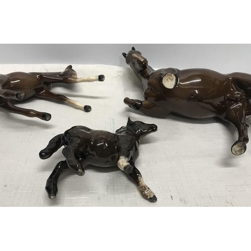 25 - Royal Doulton brown horse and foal, horse 19.5cms h, foal 11cms h together with a Beswick Highland P... 