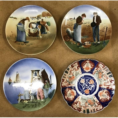 35 - Four hand painted glazed wall mounted plates to include 3 Dutch scenes of muted brown and blue and a... 