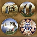 Four hand painted glazed wall mounted plates to include 3 Dutch scenes of muted brown and blue and a... 