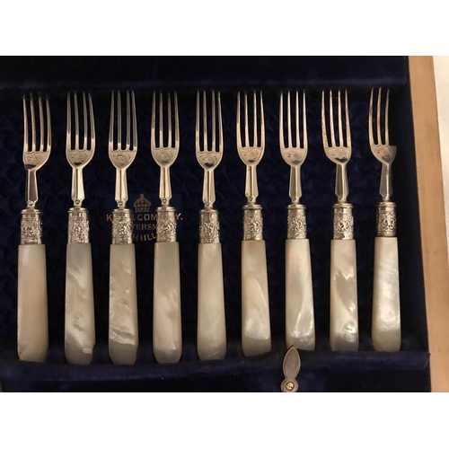 485 - A mahogany silk lined fitted box with 9 silver and mother of pearl fruit knives and forks, Sheffield... 